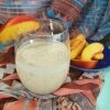 vegan peach pie smoothie next to peaches