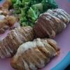 hasselback potatoes with butter cheese black truffle salt on plate