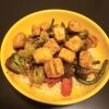 tofu stir fry with noodles on yellow plate